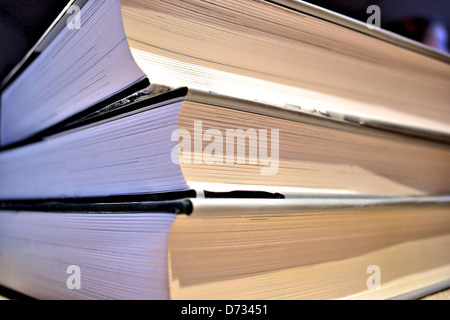 three thick books lying on a table Stock Photo