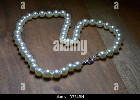 a pearl necklace on a table Stock Photo