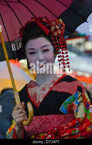 Geisha in kimono with umbrella walking on the street in rain, Asakusa, Tokyo, Japan Stock Photo