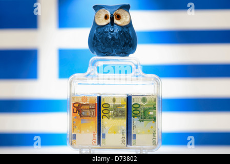 Owl on monetary suitcase before Greece flag, EU facilities to Greece Stock Photo