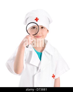 Portrait of a smiling little girl wearing as a nurse on white uniform and holding in right-hand a magnifying glass Stock Photo