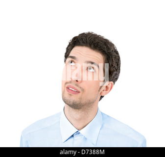 Handsome young businessman looking up at copyspace. Isolated on white background Stock Photo