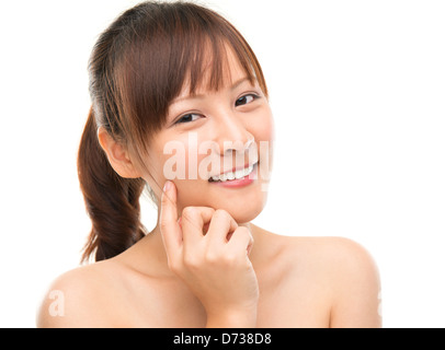 Skin care woman putting face cream touching her cheek. Facial beauty closeup of beautiful mixed race Asian female model isolated on white background. Stock Photo