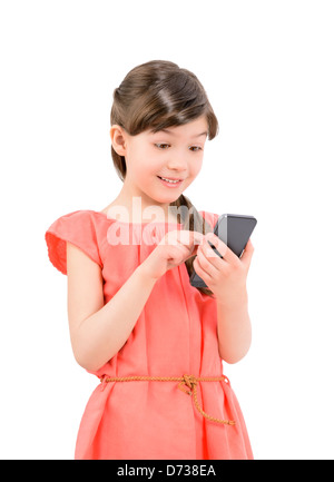 Wondering little cute girl in red dress surprised with an interesting information on mobile smartphone Stock Photo