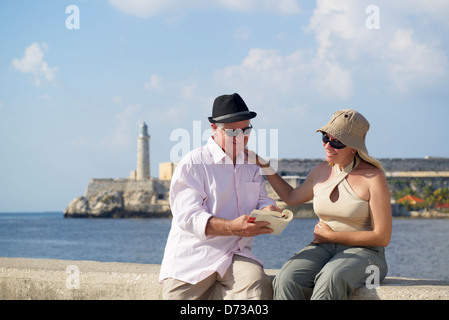 Tourism and active retirement with elderly people traveling, senior couple having fun on holidays in Havana, Cuba Stock Photo