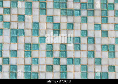Background of teal blue and white ceramic small square tiled wall.