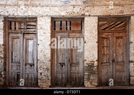 Three ramshackle old doors side by side (Greece) Stock Photo