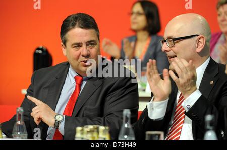 The Premier of Schleswig-Holstein, Torsten Albig (SPD, R) and the chairman of the SPD  Sigmar Gabriel (L) sit next to each other during the SPD party conference in Buedelsdrof, Germany, 28 April 2013. Amongst other issues the conference was concered with the lists of candidates to run on the SPD's party ticket on state level for the forthcoming Bundestag parliamentary election in Autumn 2013. Photo:  Carsten Rehder Stock Photo