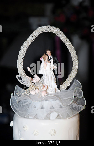 Bride and groom topper on wedding cake Stock Photo