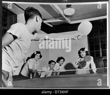 Boy and girl play ping-pong, circa 1950 Stock Photo