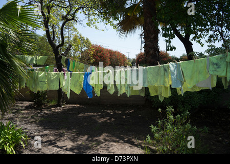 Rags used to clean cars at a high school fund raising car wash dry on a clothesline. Stock Photo