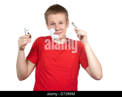 The boy, the teenager the first time tries to have a shave and is confused.. Stock Photo