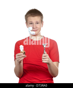 The boy, the teenager the first time tries to have a shave and is confused.. Stock Photo