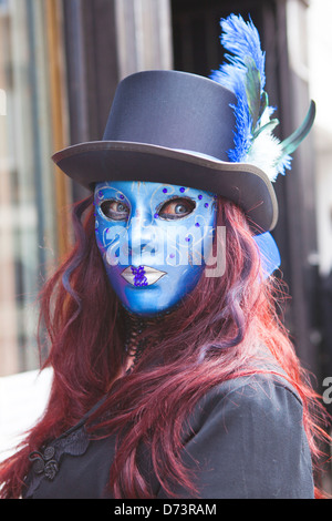Mysterious young woman in blue mask and strange contact lenses. Stock Photo
