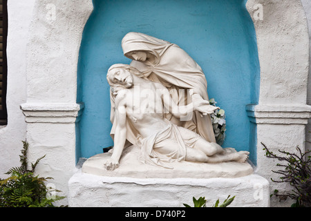 Pieta statue in the garden of the Mission Basilica San Diego de Alcala, the first Mission in California. Stock Photo