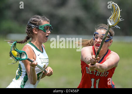 Jacksonville, FL, U.S - April 28, 2013: Detroit Titans defender Britany Busch (11) attempts to defend a goal shot by Jacksonville attack Brittney Orashen (29) during NCAA Women's Lacrosse ASUN Championship game action between the Detroit Mercy Titans and the Jacksonville Dolphins. Jacksonville defeated Detroit Mercy 22-8 at Southern Oaks Stadium in Jacksonville, FL/Alamy Live News Stock Photo