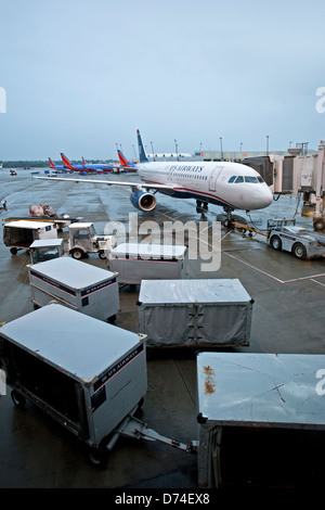Baggage carts on the runway. Heathrow airport. London. UK Stock Photo