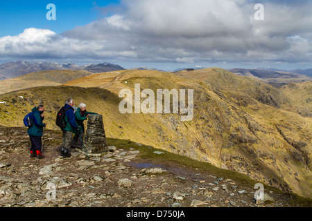 Seniors lifestyle: Hikers admiring the view on the Coniston horseshoe in spring, Lake District, UK Stock Photo