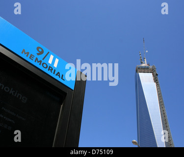 Entrance to the National 9/11 Memorial.  World Trade Center Tower One under construction in the background. Stock Photo