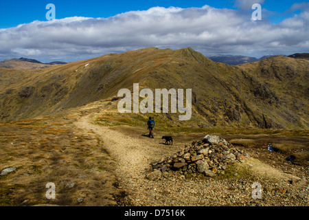 Person walking towards Great How, Old Man of Coniston horseshoe, Lake District, UK Stock Photo