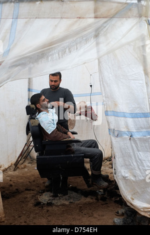 A barber in the refugee camp Azaz Camp, Syria Stock Photo