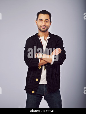 Portrait of a smiling fashionable guy standing in a studio Stock Photo