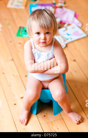 18 month old baby girl on chamberpot. Stock Photo