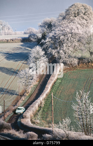 Hoar frost landscape, Hertfordshire, UK, rural scene, low winter sunshine. Country lane with car Stock Photo