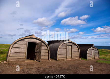 A trio of fishermens huts, made from upturned old boats, on the island of Lindisfarne Stock Photo