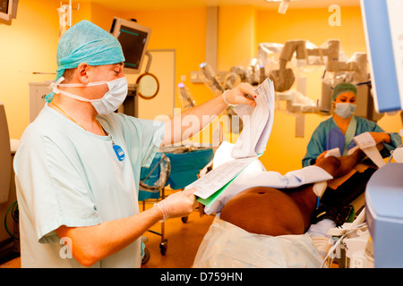 Prostatectomy performed by telesurgery robot Da Vinci which four articulated arms camera are controlled distance by surgeon Stock Photo