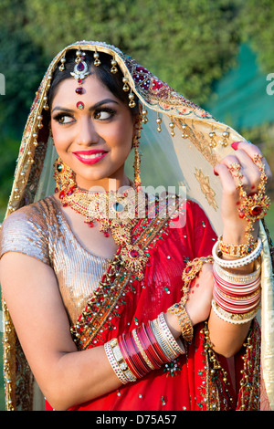 Beautiful Indian bride in traditional wedding dress and posing Stock Photo