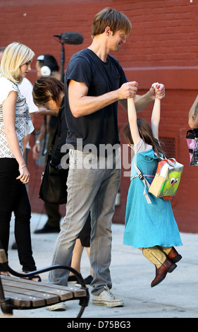 Alexander Skarsgard playing with a young actress on the film set of 'What Maisie Knew' shooting in Manhattan New York City, USA Stock Photo