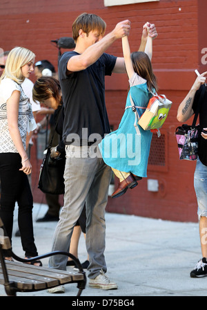 Alexander Skarsgard playing with a young actress on the film set of 'What Maisie Knew' shooting in Manhattan New York City, USA Stock Photo