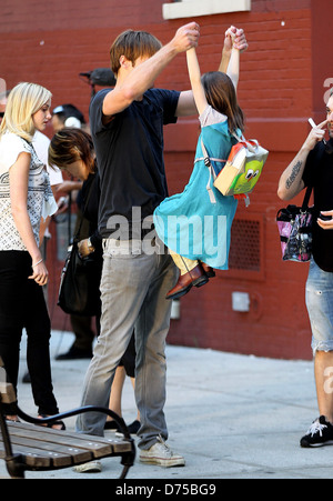 Alexander Skarsgard playing with a young actress on the film set of 'What Maisie Knew' shooting in Manhattan New York City, USA Stock Photo