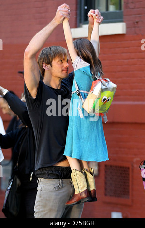 Alexander Skarsgard playing with a young actress on the film set of 'What Maisie Knew' shooting in Manhattan New York City, USA Stock Photo