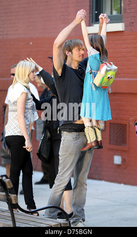 Alexander Skarsgard playing with a young actress on the film set of 'What Maisie Knew' shooting in Manhattan New York City, USA Stock Photo