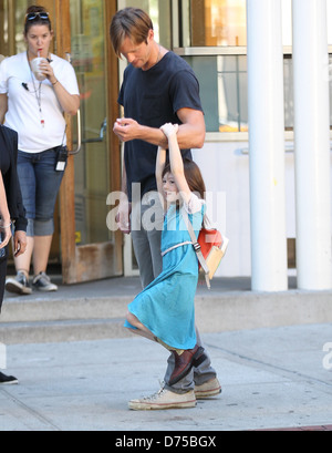 Alexander Skarsgard playing with a young actress on the film set of 'What Maisie Knew' shooting in Manhattan New York City, USA Stock Photo