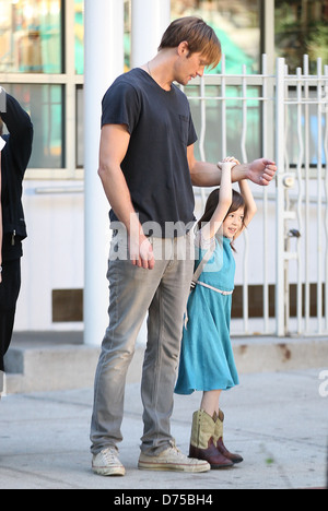 Alexander Skarsgard playing with a young actress on the film set of 'What Maisie Knew' shooting in Manhattan New York City, USA Stock Photo