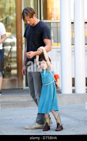 Alexander Skarsgard playing with a young actress on the film set of 'What Maisie Knew' shooting in Manhattan New York City, USA Stock Photo