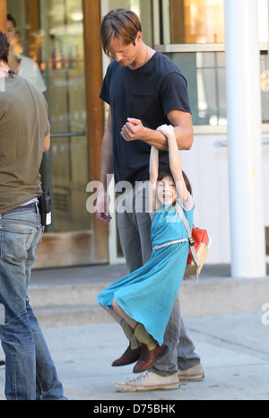 Alexander Skarsgard playing with a young actress on the film set of 'What Maisie Knew' shooting in Manhattan New York City, USA Stock Photo