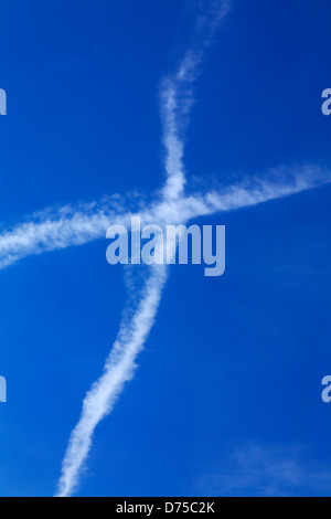 condensation trail forming a air cross in the sky Stock Photo