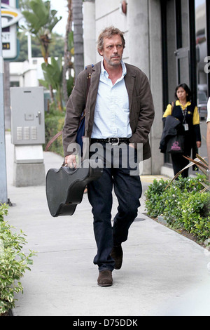 Hugh Laurie carrying his guitar as he arrives at LAX airport on a flight from London Los Angeles, California - 20.07.11 Stock Photo