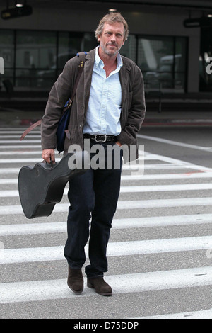 Hugh Laurie carrying his guitar as he arrives at LAX airport on a flight from London Los Angeles, California - 20.07.11 Stock Photo