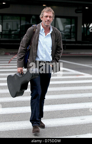 Hugh Laurie carrying his guitar as he arrives at LAX airport on a flight from London Los Angeles, California - 20.07.11 Stock Photo