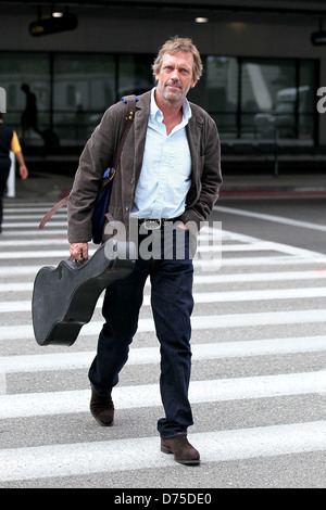 Hugh Laurie carrying his guitar as he arrives at LAX airport on a flight from London Los Angeles, California - 20.07.11 Stock Photo