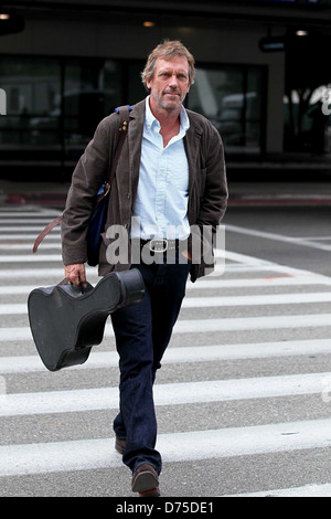 Hugh Laurie carrying his guitar as he arrives at LAX airport on a flight from London Los Angeles, California - 20.07.11 Stock Photo