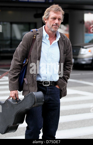 Hugh Laurie carrying his guitar as he arrives at LAX airport on a flight from London Los Angeles, California - 20.07.11 Stock Photo