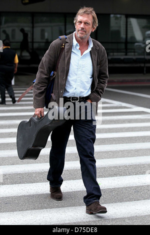 Hugh Laurie carrying his guitar as he arrives at LAX airport on a flight from London Los Angeles, California - 20.07.11 Stock Photo