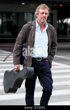 Hugh Laurie carrying his guitar as he arrives at LAX airport on a flight from London Los Angeles, California - 20.07.11 Stock Photo