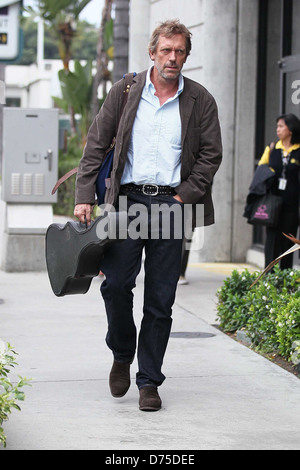 Hugh Laurie carrying his guitar as he arrives at LAX airport on a flight from London Los Angeles, California - 20.07.11 Stock Photo